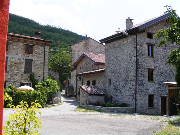 Stone houses with tiled roofs in a mountain village, daylight