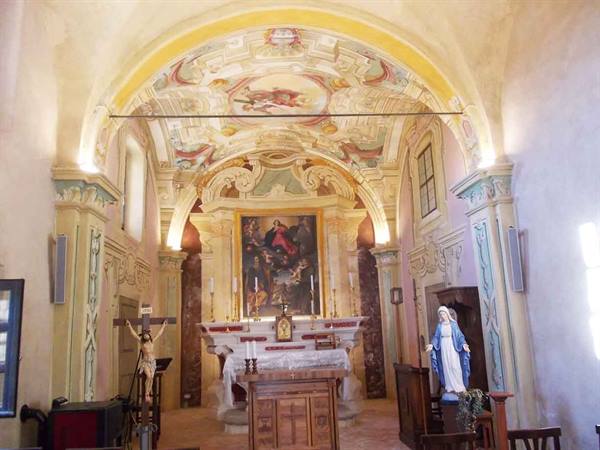 Baroque church interior with marble altar, frescoed vault ceiling and Madonna statue