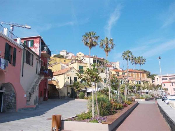 Square with palm trees and colorful houses along Sestri Levante waterfront