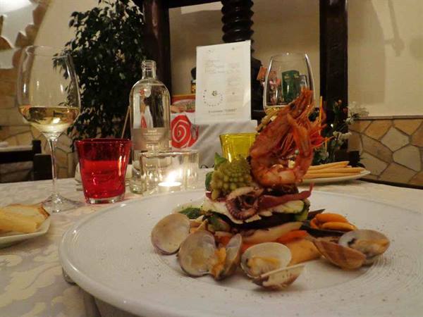 Seafood platter with prawn and clams, candles glowing on the table