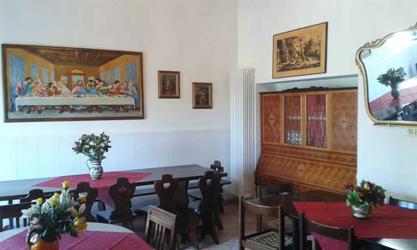 Dining room with Last Supper copy, inlaid cabinet and tables with red tablecloths