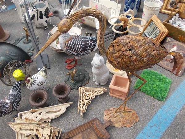 Flea market: metal heron statue among ceramics and assorted ornaments