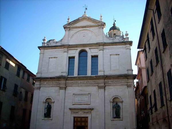 White facade of San Giovanni Battista basilica in Chiavari among old buildings