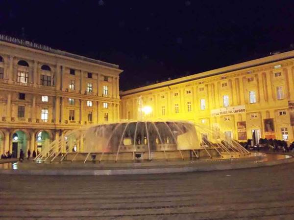 The illuminated fountain in Piazza de Ferrari, Genoa, at night
