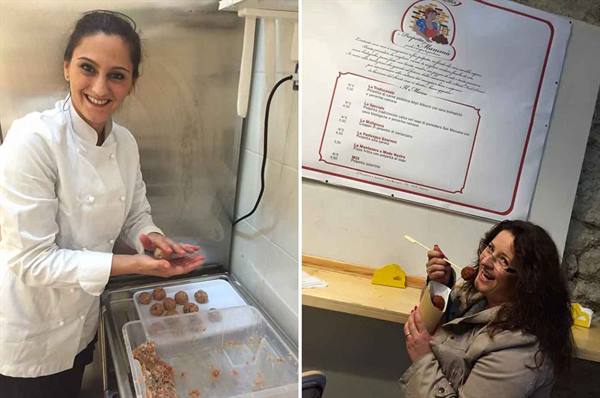 Chef in white prepares meatballs, tourist tastes street food from a cone