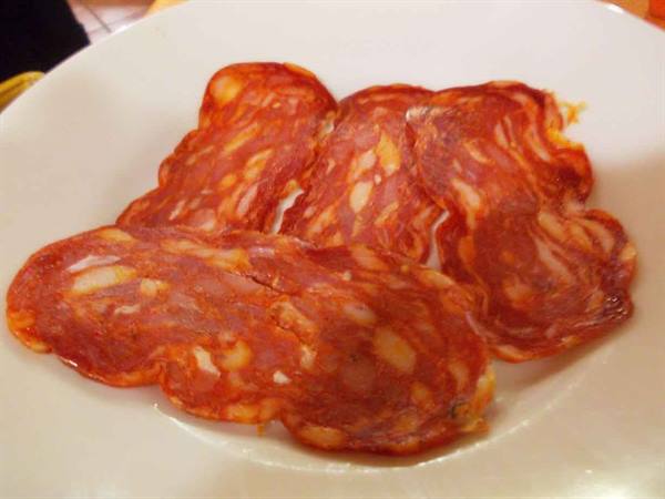 Slices of marbled salami served on a white plate