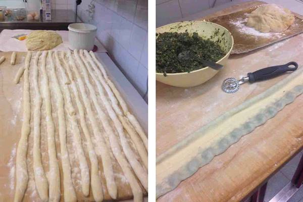 Fresh dough strips and spinach filling being prepared on a wooden board