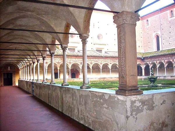 Cloister with marble columns and arches, natural light on inner garden