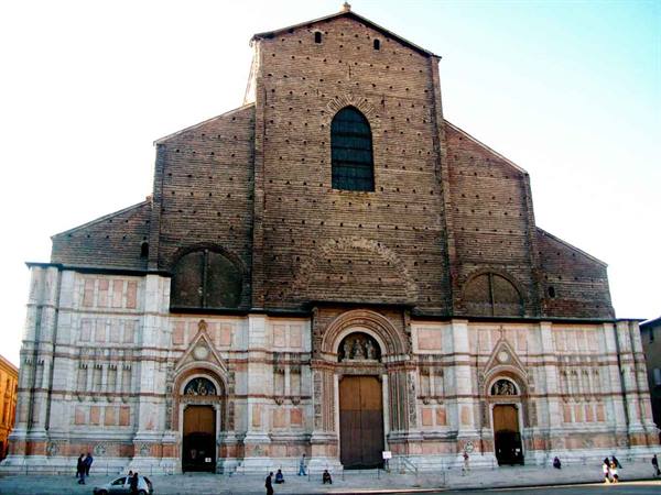 Brick and marble facade of San Petronio in Bologna under sunlight