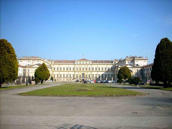 Villa Reale di Monza, neoclassical façade under blue sky, lawn and avenue in front