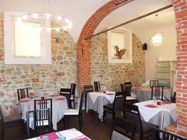 Restaurant dining room with brick vaults, stone walls and set tables