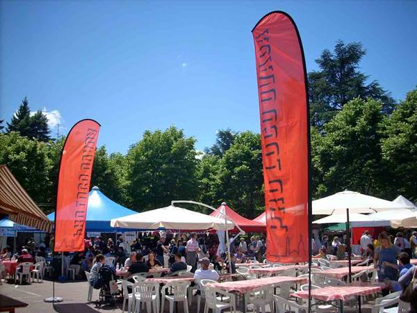 Orange banners flying over tables at a kosher food festival