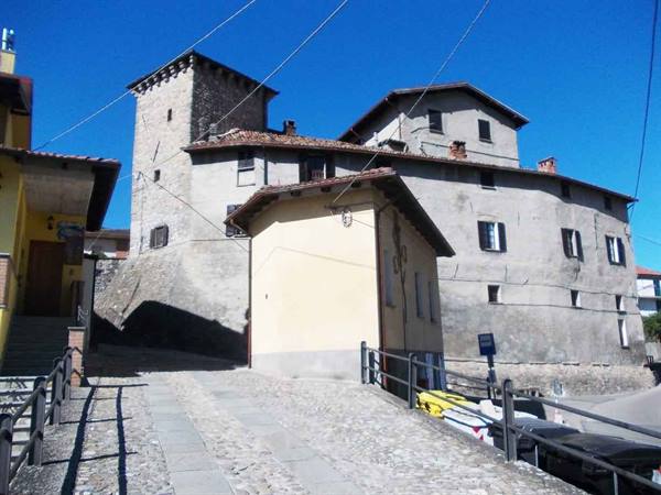 Castle of Saliceto, ancient stone building with tower under blue sky
