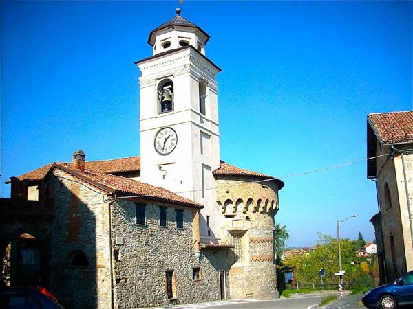 White bell tower with clock on ancient stone rotunda under blue sky