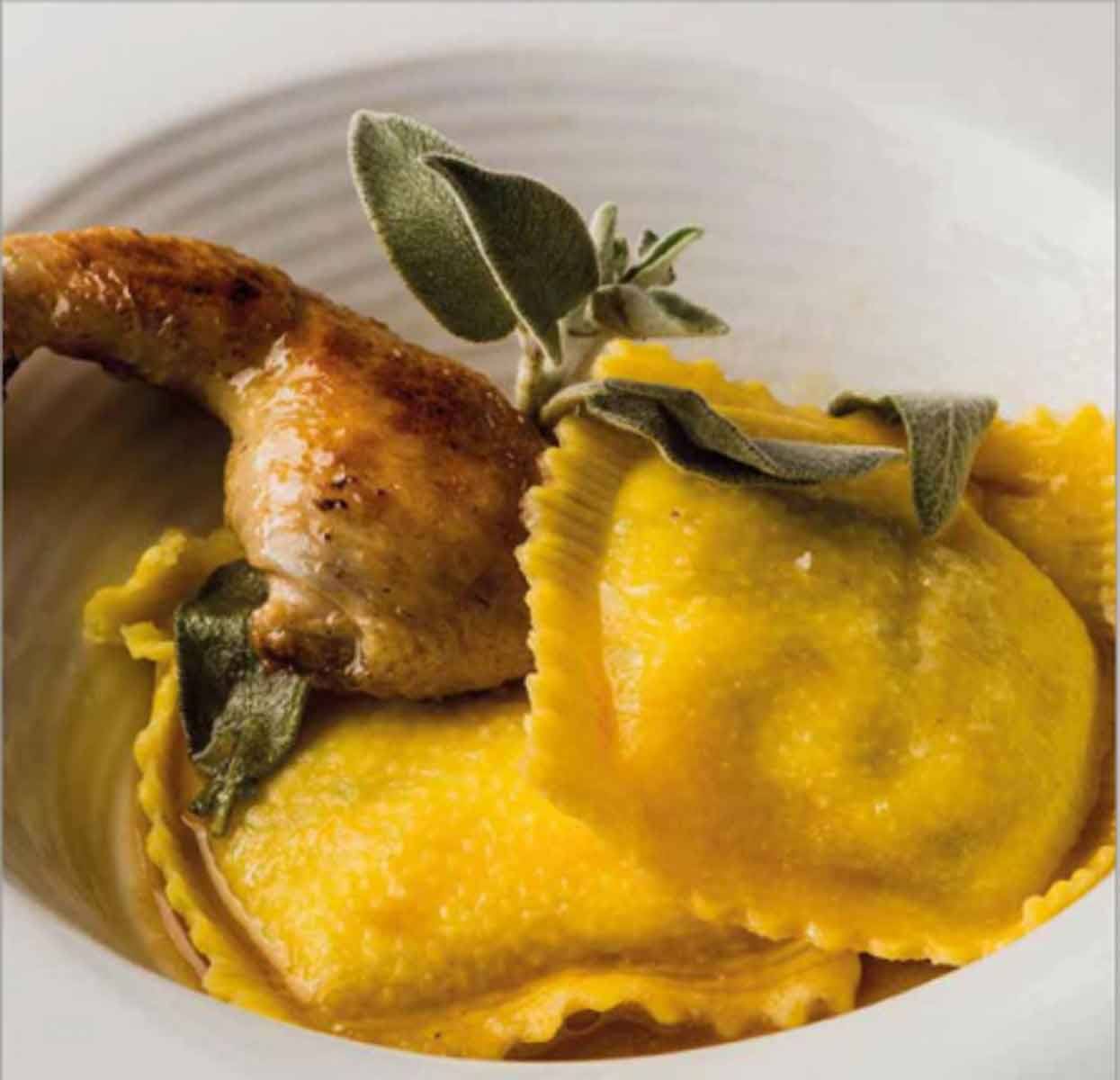 Ravioli gialli al burro e salvia con coscia arrostita in piatto bianco