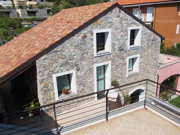 Stone house with terracotta tiled roof and sunny terrace