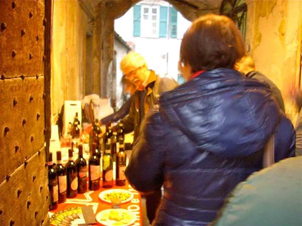 Wine tasting with bottles and food in an old alley doorway