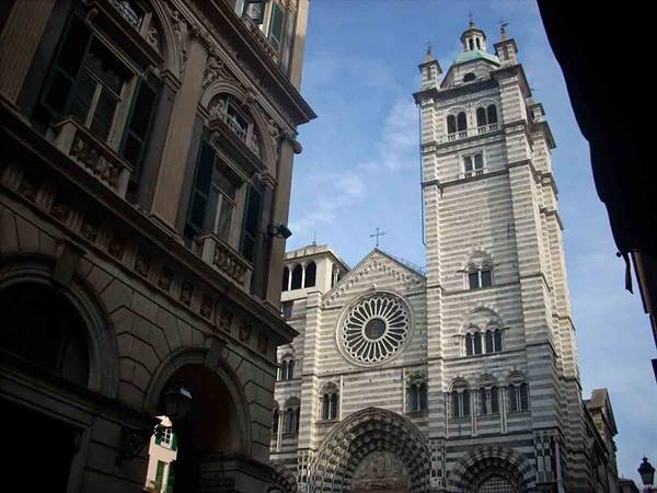 Romanesque striped facade of Genoa's San Lorenzo Cathedral under blue sky