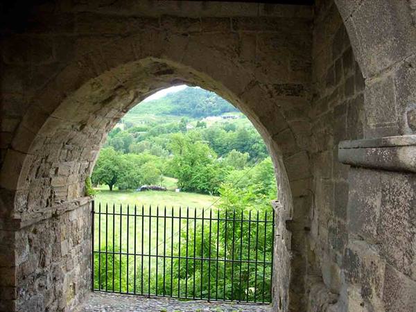The green of the countryside through the arch of the Portino