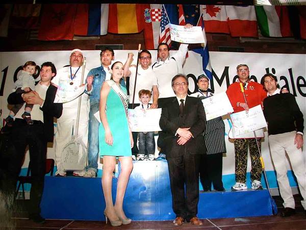 Winners holding diplomas on podium, international flags and miss in green