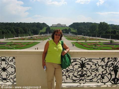 Woman in green by the wrought-iron balustrade of the Belvedere gardens