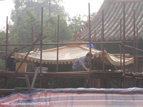 Workers busy rebuilding the roof