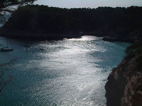 cala mitjana..sun reflecting on the water almost at sunset 