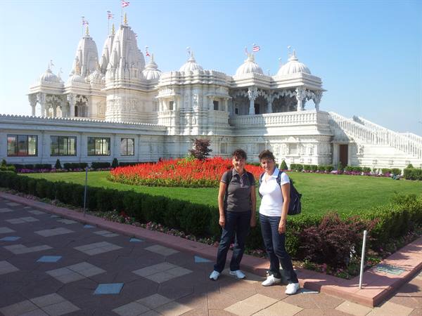 Two tourists in front of the white marble BAPS temple in Atlanta