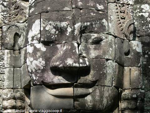 Giant carved stone face on the Bayon temple towers, Angkor