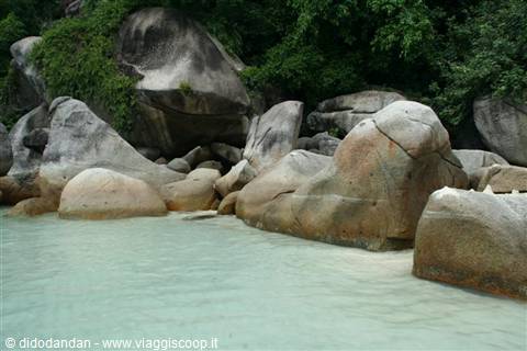 Huge granite boulders rise from turquoise water, resembling the Similan Islands
