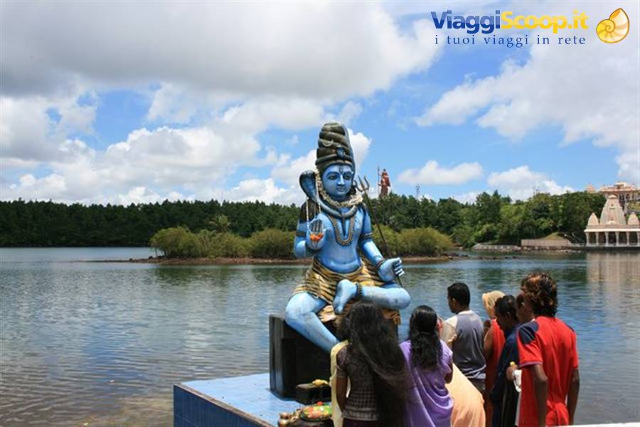 Tourists before the blue seated Shiva statue by the lake at Grand Bassin