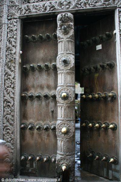 Old carved wooden door with brass studs, typical of Stone Town