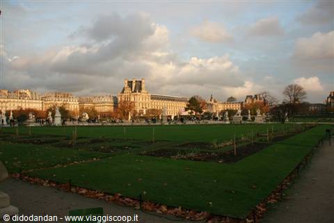Tuileries Garden with lawn and statues, the Louvre in the background, Paris