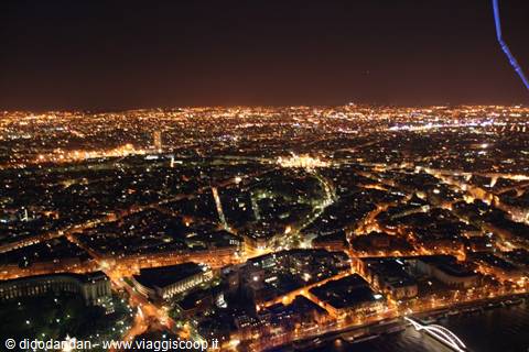 Paris by night from the Eiffel Tower, golden lights over rooftops and the Seine