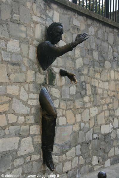 Bronze statue of Le Passe-Muraille emerging from stone wall, Montmartre