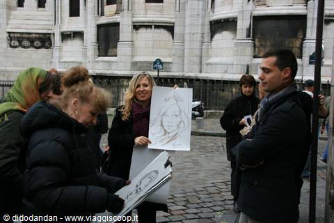 Portrait artist showing a charcoal drawing to tourists in front of the white stone basilica