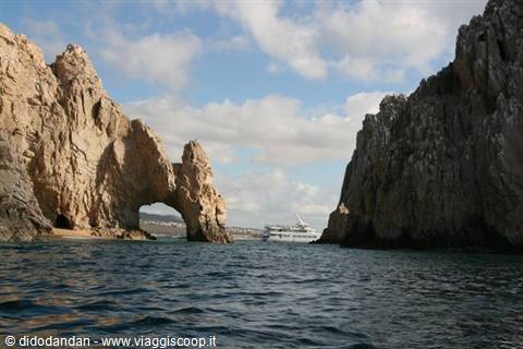 El Arco de Cabo San Lucas, limestone rock arch, white ship passing beyond
