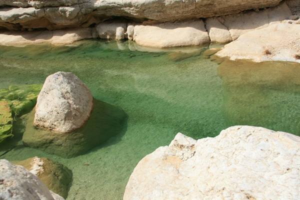 White rocks and clear emerald green water among limestone stone