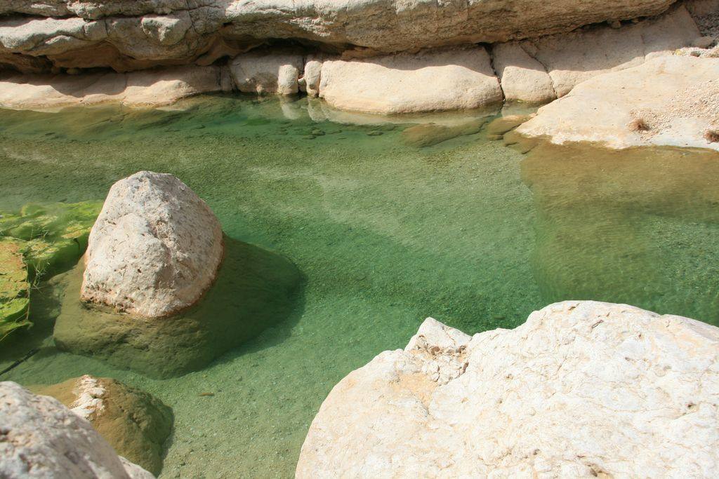 White rocks and clear emerald green water among limestone stone