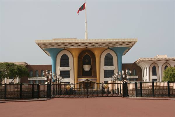 Al Alam Palace in Muscat, blue and golden facade with Omani flag