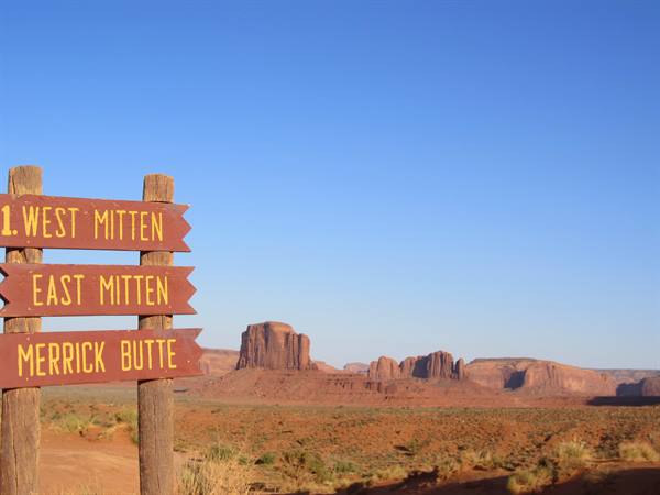 Wooden signs point to West Mitten, East Mitten and Merrick Butte in Monument Valley