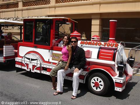 Couple sitting on the red Monaco-Tour tourist train on a sunny street