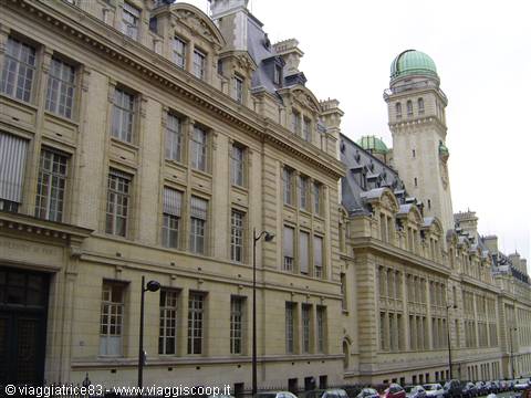 Pale stone facade of the Sorbonne in Paris with green astronomical tower