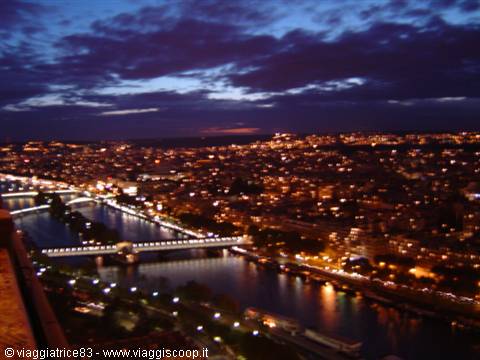Paris at night: the Seine and Pont d'Iéna lit under a blue sky