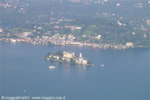 Fishermen's Island on Lake Maggiore with boats and villages along the shore