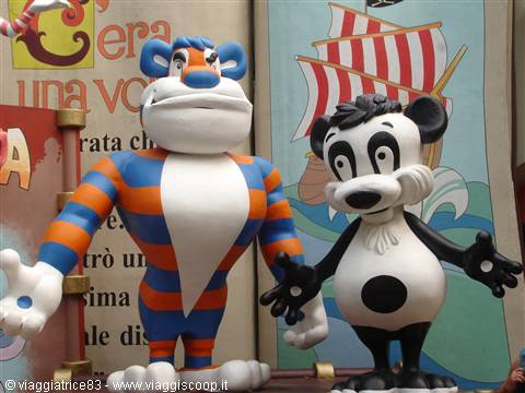 Painted mascot statues: orange and blue striped tiger beside a black and white panda