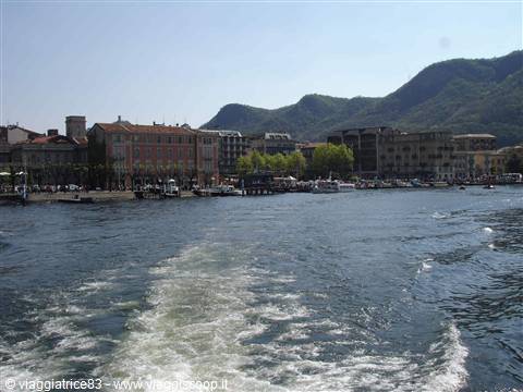 Como's waterfront seen from the ferry, wake trailing across the lake water