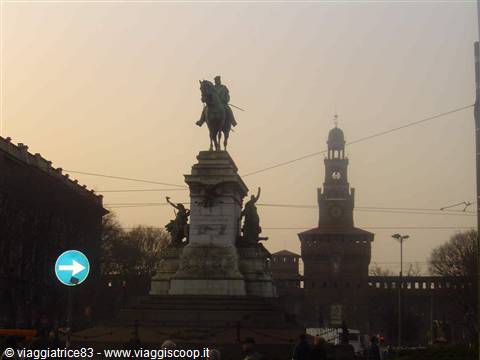 Equestrian bronze monument in front of Milan's Castello Sforzesco in morning haze