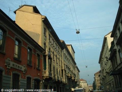 Art Nouveau buildings along a city street with trolleybus wires, Milan