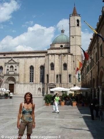 Smiling tourist in the square in front of San Francesco church, Ascoli Piceno
